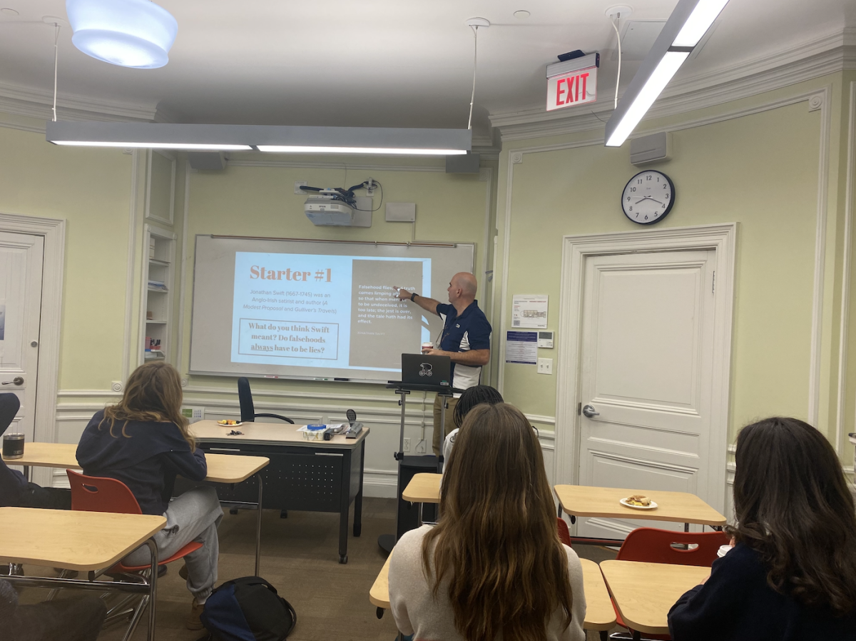 Economics and Theory of Knowledge (TOK) teacher Guy Neal teaching his eleventh grade TOK class. (Courtesy of Shane Royster) 